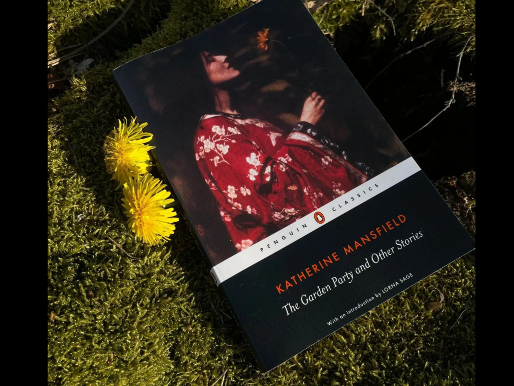 Paperback of Katherine Mansfield 'The Garden Party' in the grass next to dandelions